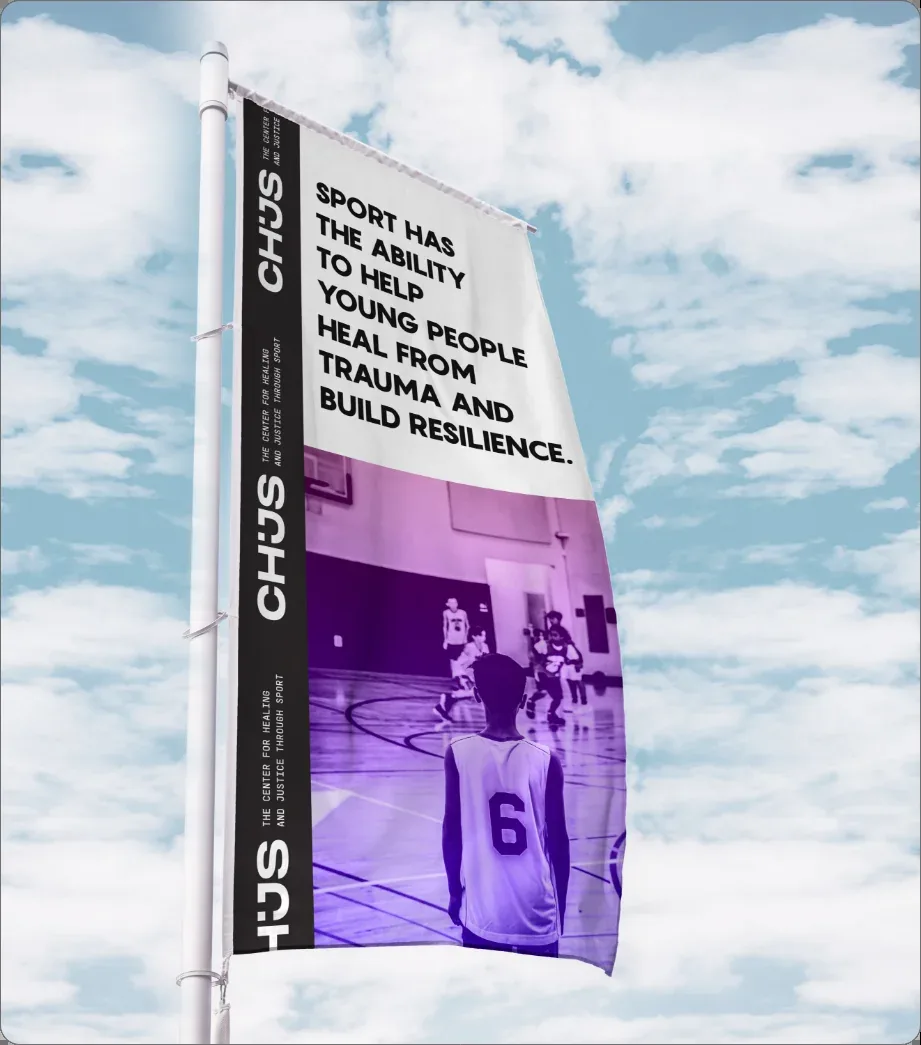 A CHJS flag against the sky: “Sport has the ability to help young people heal from trauma and build resilience.”